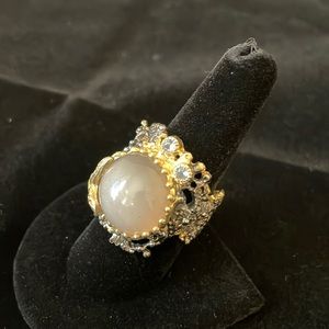 Silver ring with rose quarts, two blue gemstone accents and gold starfish.